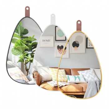 Pebble shaped gold-rimmed mirror